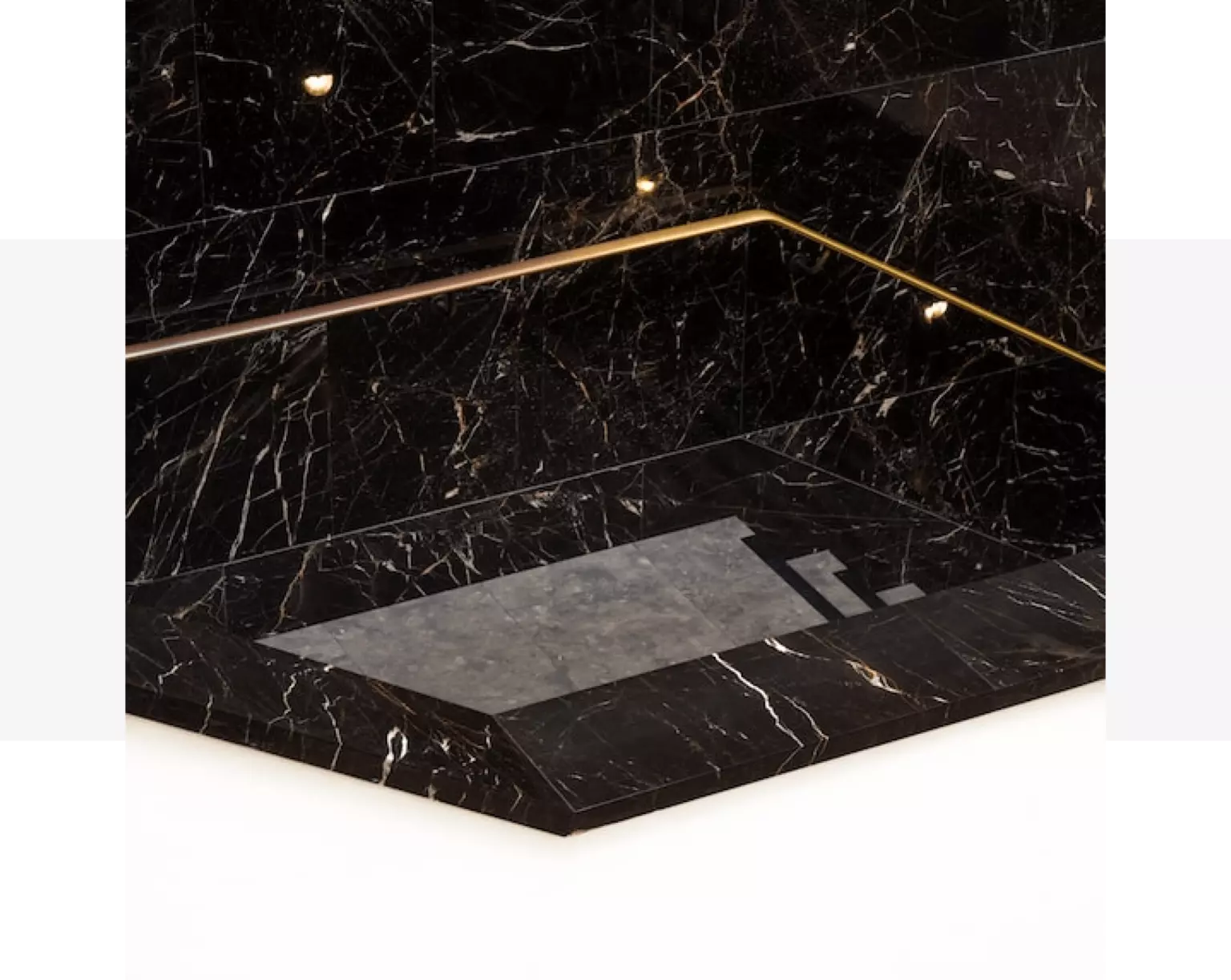 A black quartz sink with a gold trim.