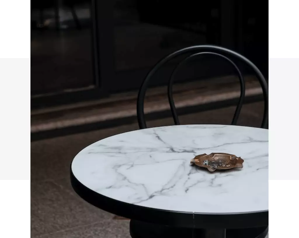 A table with a black quartz benchtop and a chair.