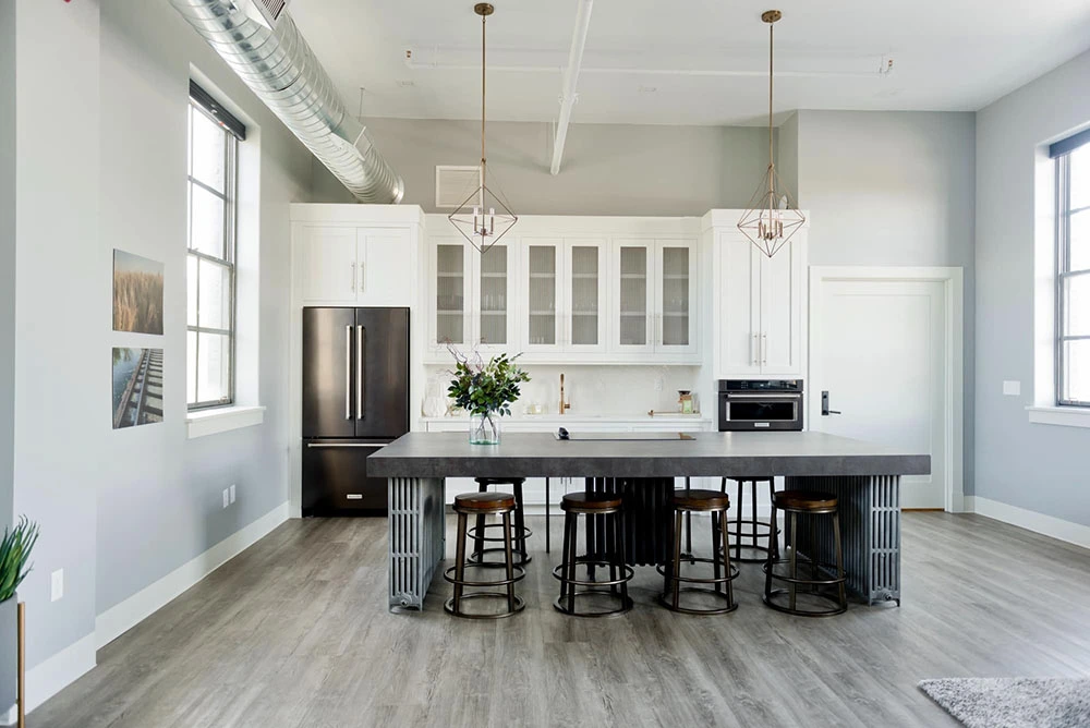 A white kitchen with wood floors and stools offering warranty registration.