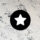 A black and white star on a marble background.